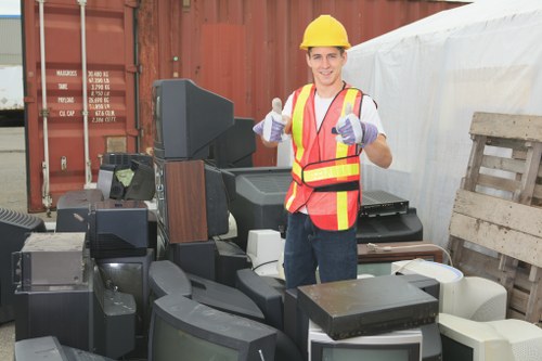 Construction site with builders managing waste in Barking